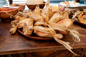 Small tamales called Chuchitos, typical Guatemalan food, made of corn dough and meat with a sauce called recado, traditional diet. - 548858620