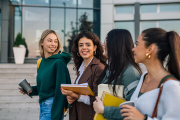 Young women walk past the college building