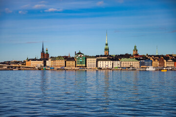 Scenic morning view of Gamla Stan in Old Town Stockholm, panorama embankment capital of Sweden with blue sky. Background of amazing urban scenery view of Scandinavian architecture. Copy text space