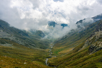 Fototapeta premium Mountain landscape with clouds on the valley and river