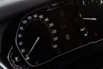 Modern car dashboard with speedometer, tachometer. Car dashboard. Car dashboard details. Modern car interior. The speedometer of a modern