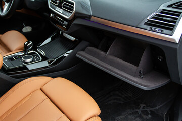 Opened car glove box compartment. Glove compartment of car.