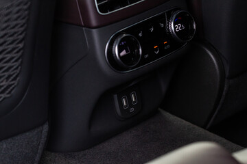 Opened car USB port in the car for connecting device. Power output of usb charger close up view....