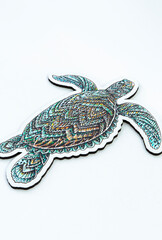 Fototapeta premium wooden puzzle for children and adults in the form of a turtle. on a white background. side view. vertical arrangement