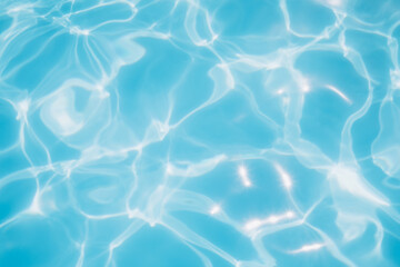 Background, blue water waves in the pool with sun reflection. Top view, selective focus