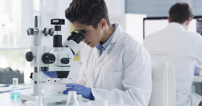 Science, medicine and woman with microscope in lab doing analysis, research and testing dna sample. Biotechnology, innovation and female scientist working with medical technology in clinic laboratory