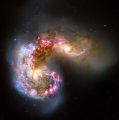 Antennae galaxies in a collision where billions of stars will be formed in space. Elements of this...
