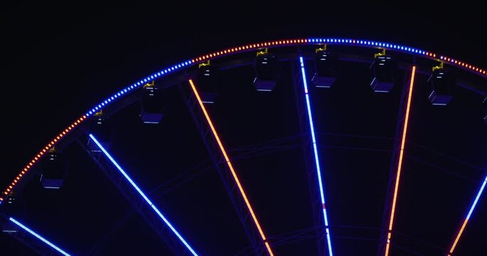 Top of Ferris Wheel Flashing Red and Blue at Night