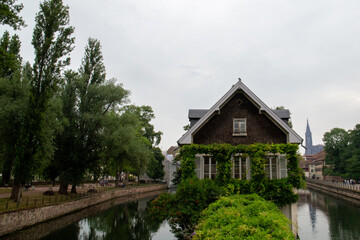 Fototapeta na wymiar House surrounded by two canals and with a green area in front