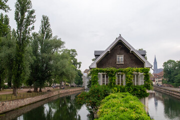 House surrounded by two canals and with a green area in front