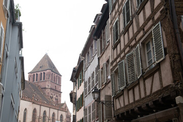 Castle in Strasbourg on a foggy day next to medieval houses
