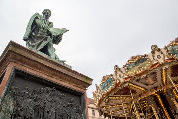 Statue next to a merry-go-round in a city in France