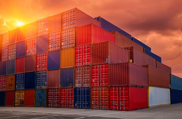 Shipping containers being unloaded at port facilities at sunset - sunrise