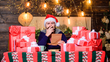 Fulfill cherished dreams. Happy winter holidays. Man bearded santa claus hat reading letters....