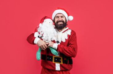 happy bearded man with toy in santa claus costume celebrate winter holiday of chistmas and feel merry about xmas gifts, shopping