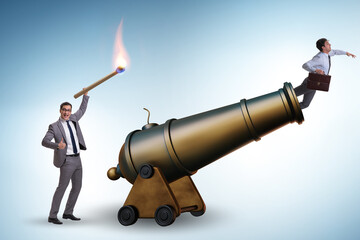 Concept of lay-off with businessman and cannon