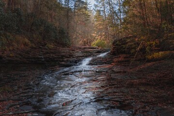Cascades at bottom of a waterfall in the season of autumn
