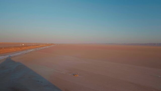 Chott el Djerid lake almost dried due to weather contition in desert. Tourists sightseeing of dried lake in sahara desert.