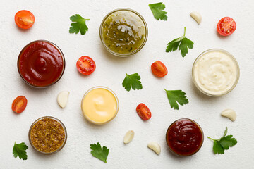 Many different sauces and herbs on table, flat lay top view. sauces with spices healthy concept