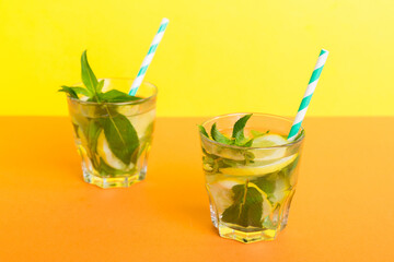 Mojito summer refreshing cocktail with ice and mint. mojito cocktail with lime, lemon and mint in a tall glass with a stick