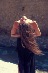 Sun Worship woman with long hair by a natural spring,  - 548878069