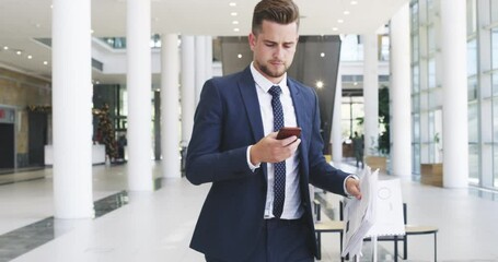 Businessman, phone and travel luggage, social media and notification while walking to get international flight. Professional reading a time and schedule of transport online while walk with suitcase - Powered by Adobe