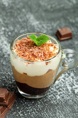 dessert three chocolates with mint on a light background. Layered delicious dessert. vertical image. place for text