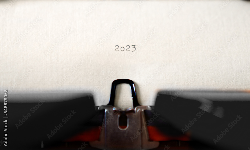 Poster old typewriter with following text on paper - 2023 chapter one. new years concept