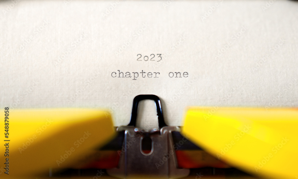 Poster old typewriter with following text on paper - 2023 chapter one. new years concept