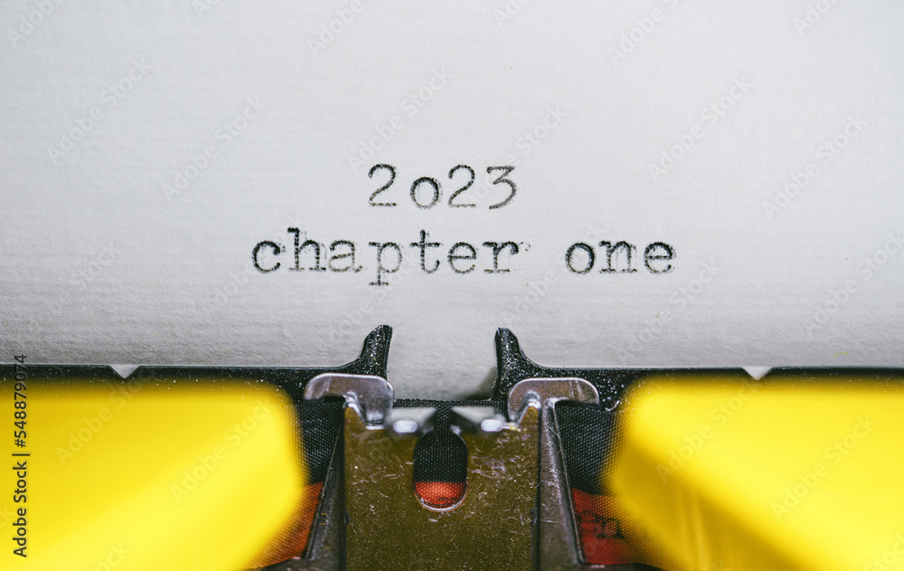 Poster old typewriter with following text on paper - 2023 chapter one. new years concept