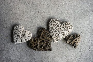 Overhead view of four handmade rustic heart ornaments on a table