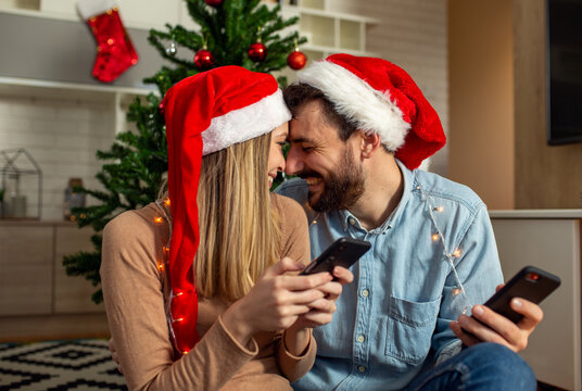 Christmas couple using phone at home