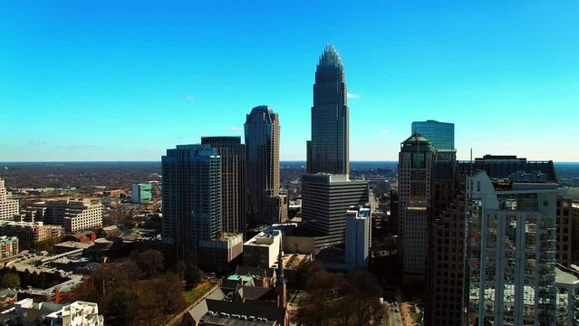 Aerial Shot Of Modern Office Buildings In Residential City, Drone Flying Backwards On Sunny Day - Charlotte, North Carolina