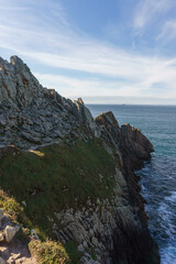 Fototapeta na wymiar Rocks at the coastline of Pointe du Raz with view at the atlantic ocean, Plogoff, Finistere, Brittany, France