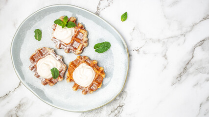 belgian waffles with icing sugar and Whipped Cream. Culinary, cooking, bakery concept on a light background, Long banner format. top view