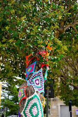Fototapeta premium colorful crochet doilies on trees in vittorio emanuele square Enna Sicily Italy