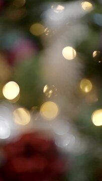 Vertical background of golden Christmas tree with decoration and lights