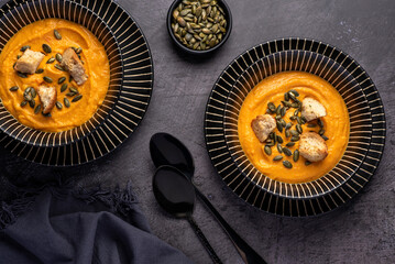 Food photography of pumpkin soup, cream,  toast, seeds, vegan