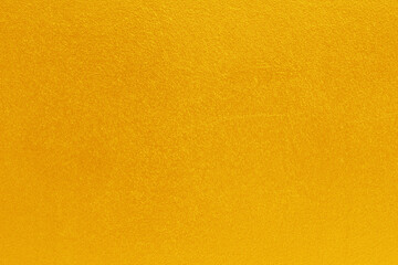 Gold or yellow paint on cement wall texture  background.