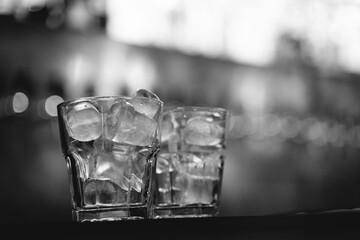 an alcoholic drink with ice is served by the bartender at the bar