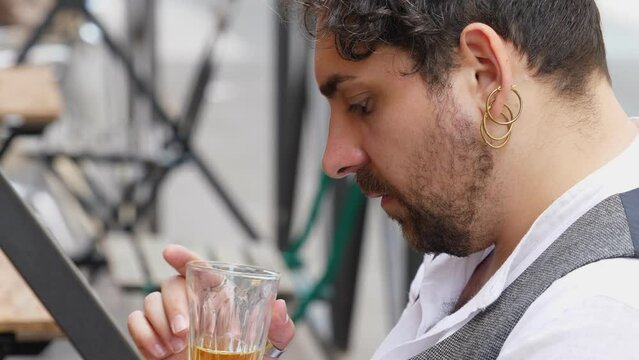 drink to forget -desperate man looks at photos of his ex on ipad and drinks 