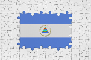 Nicaragua flag in frame of white puzzle pieces with missing central part