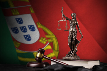 Portugal flag with statue of lady justice, constitution and judge hammer on black drapery. Concept...