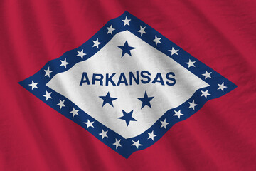 Arkansas US state flag with big folds waving close up under the studio light indoors. The official...
