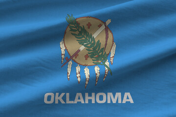 Oklahoma US state flag with big folds waving close up under the studio light indoors. The official...