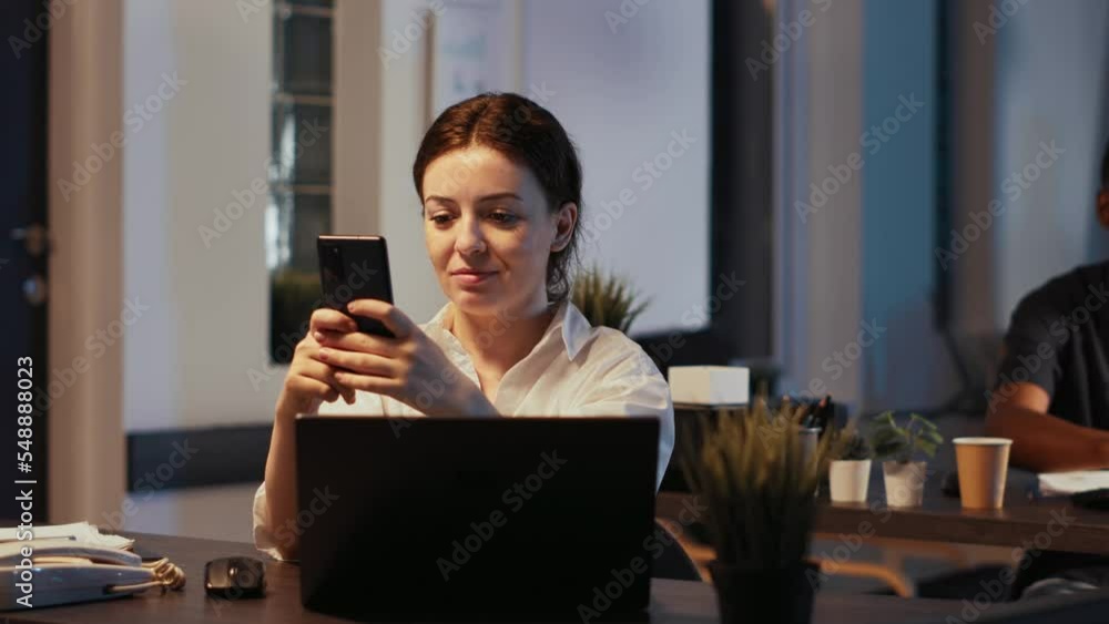 Poster portrait of happy office worker texting messages on smartphone, using investment app to work with fi