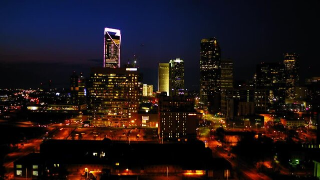 Aerial Upward Shot Of Illuminated Tall Buildings Against Clear Sky In City At Night - Charlotte, North Carolina