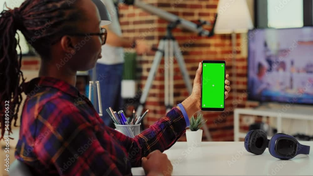 Poster modern person looking at greenscreen display on mobile phone, analyzing mockup template with blank c