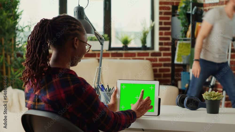 Poster young entrepreneur using digital tablet with horizontal greenscreen on display, analyzing blank copy