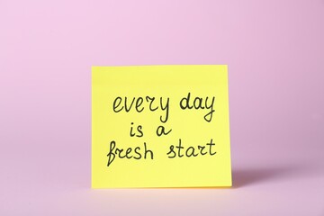 Note with phrase Every Day Is A Fresh Start on pink background. Motivational quote